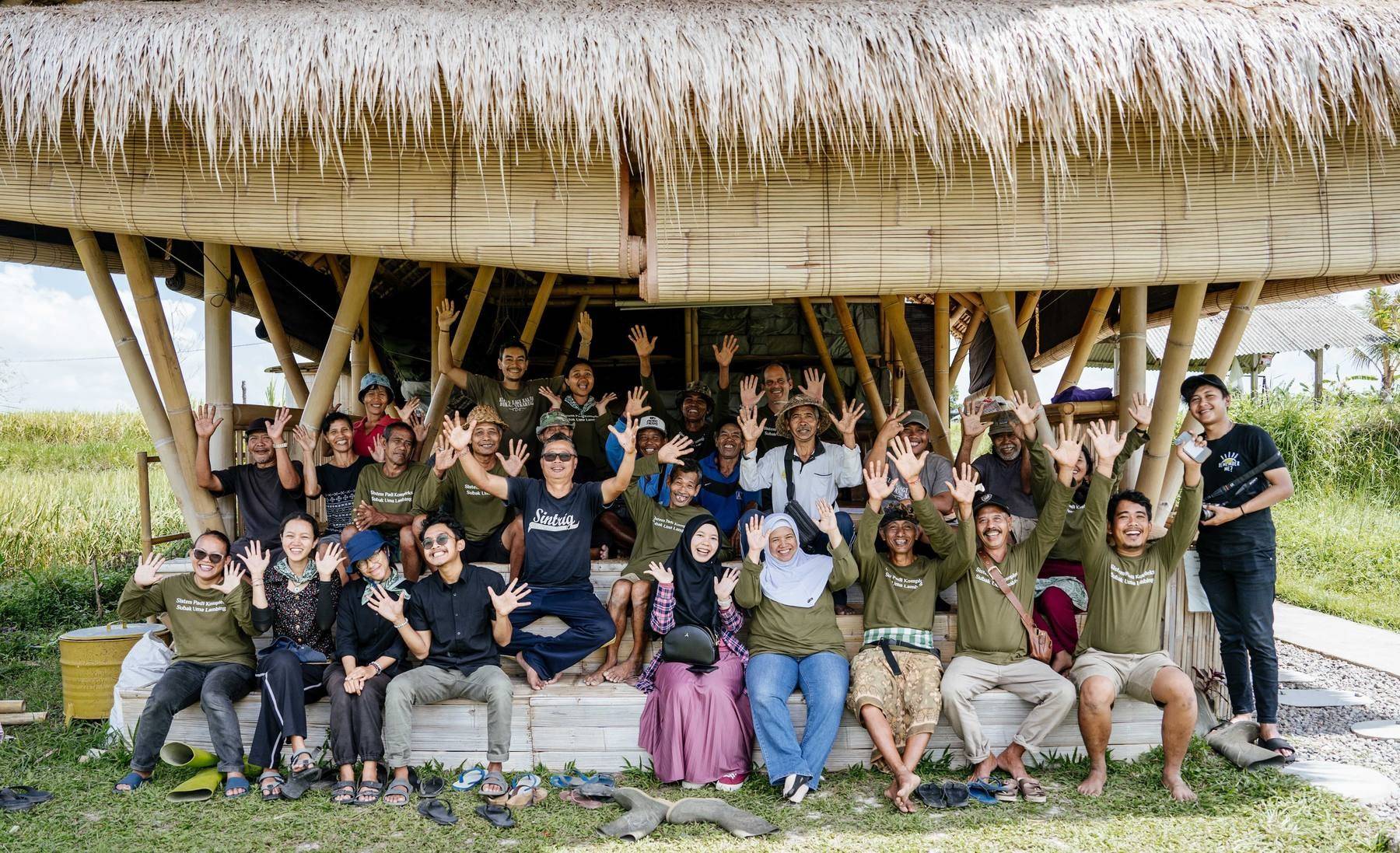 The Astungkara Way team waving from the bamboo learning center