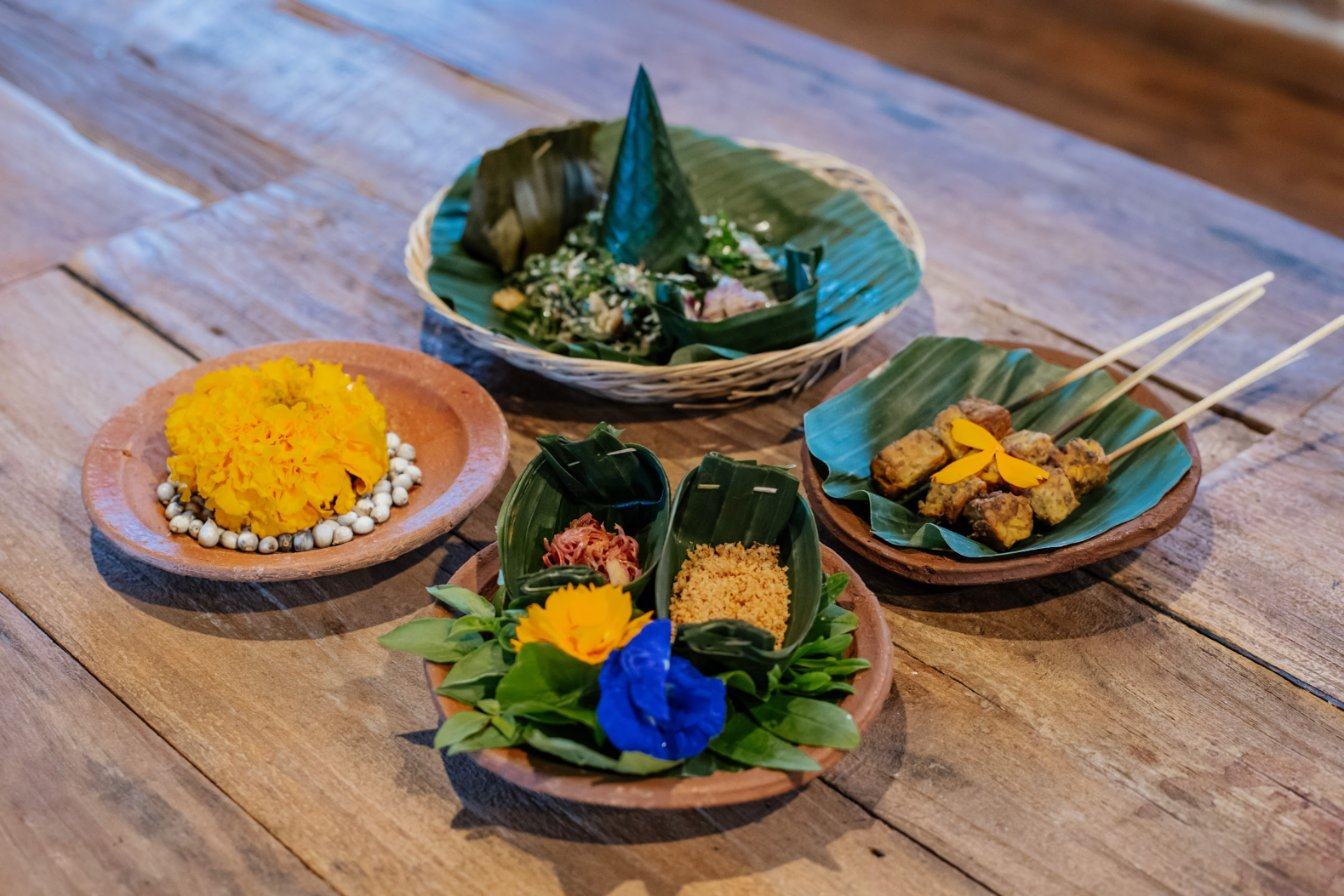 Balinese dishes from local farms served on banana leaves and clay plates