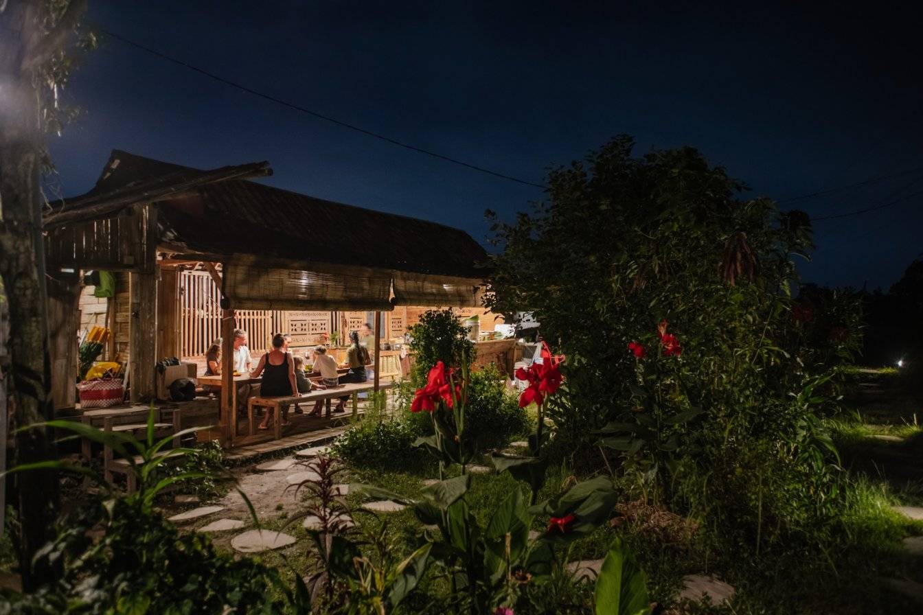 Our farm pavilion lit up at night among the rice fields