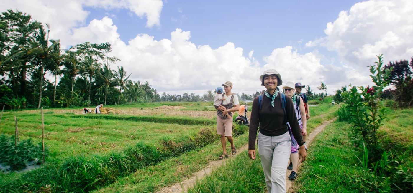 A guide walking a family through the rice fields