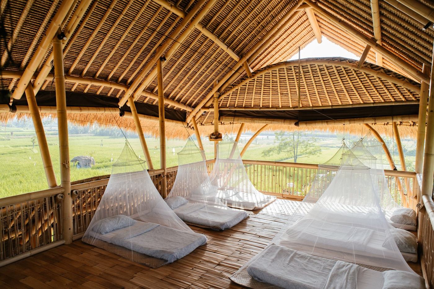 Mattresses under mosquito nets on an open bamboo platform