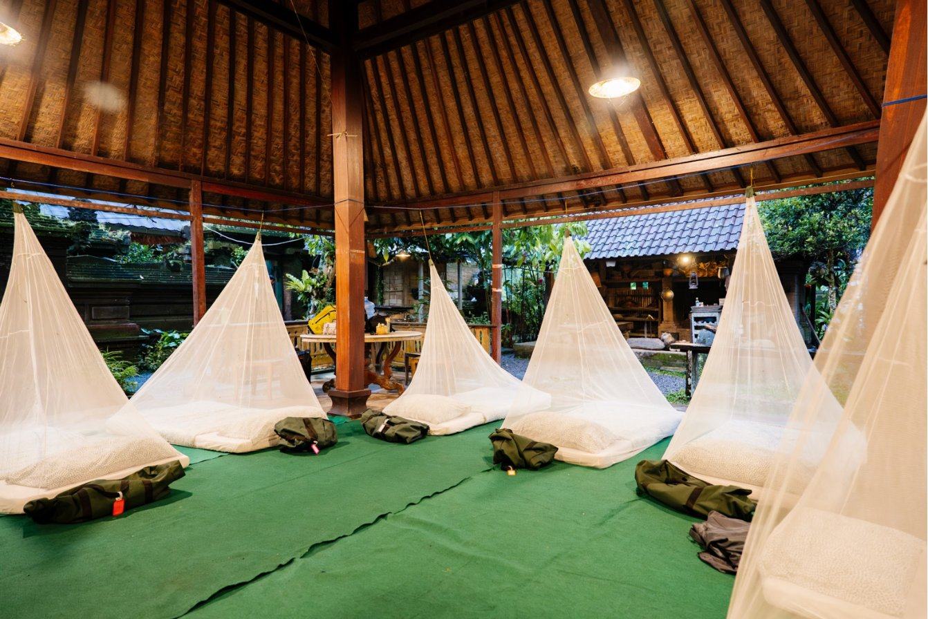 Mattresses under mosquito nets in an open pavilion
