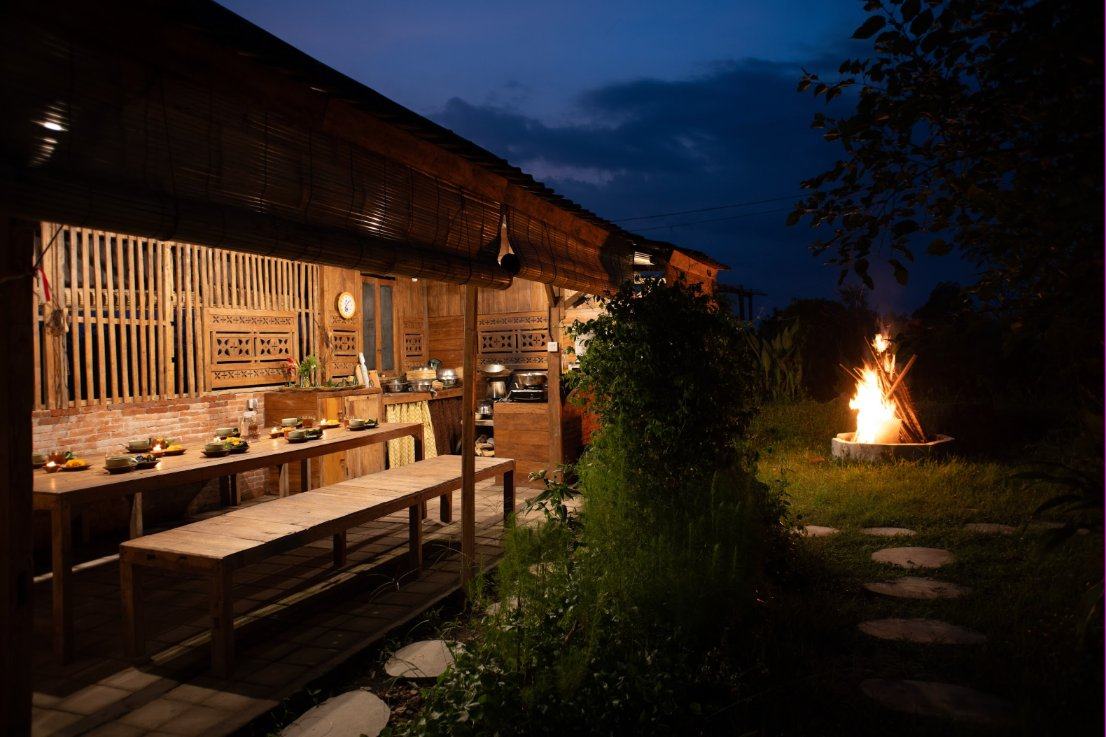 Our outdoor kitchen set for dinner, with a fire burning in the garden