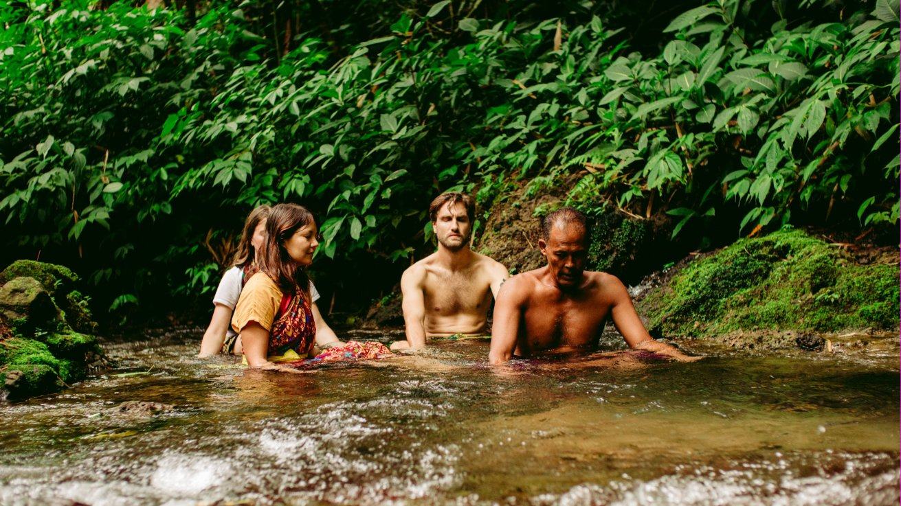 Pilgrims resting in a forest stream